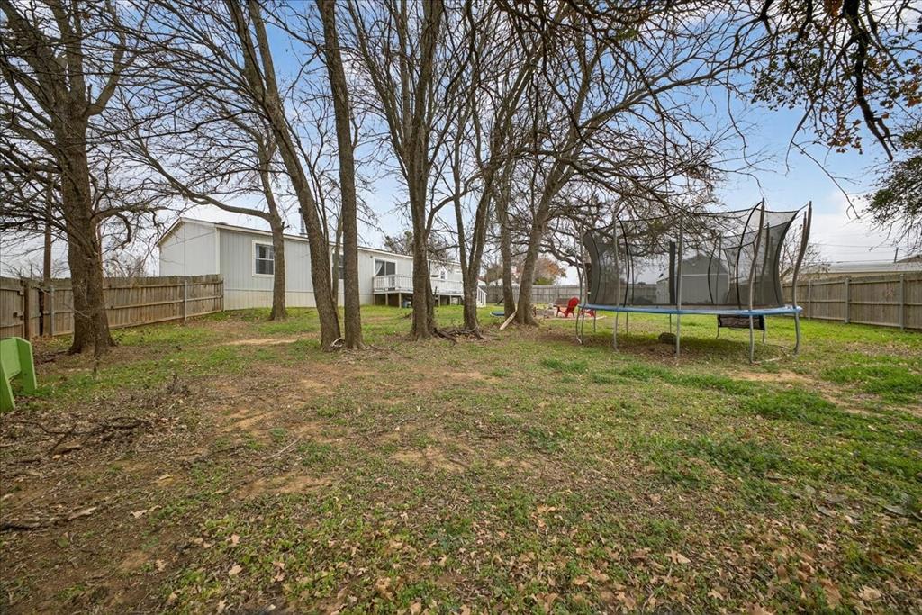 3605 Mockingbird Circle Cleburne, TX 76031 - Photo 39 of 40 Fenced backyard featuring a trampoline