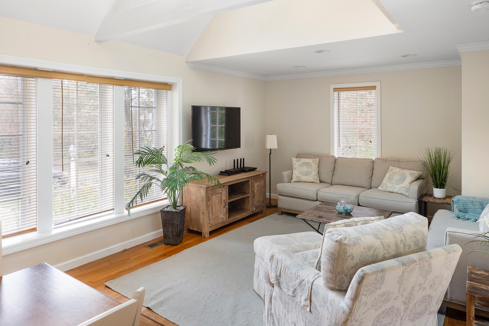 87 Schoolhouse Road Edgartown, MA 02539 - Photo 19 of 29 a living room with furniture a flat screen tv and a large window