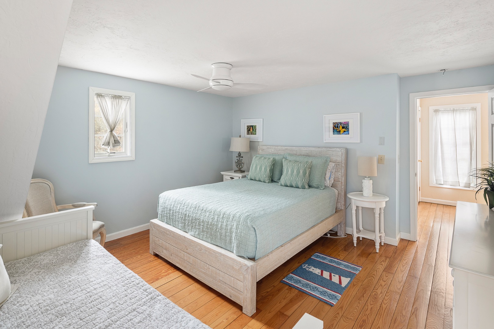 87 Schoolhouse Road Edgartown, MA 02539 - Photo 23 of 29 a bedroom with a bed and wooden floor