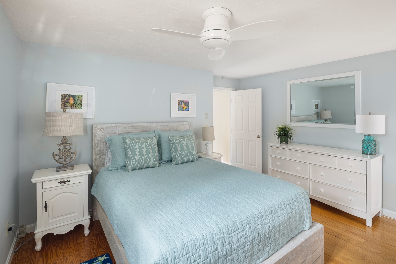 87 Schoolhouse Road Edgartown, MA 02539 - Photo 24 of 29 a bedroom with a large bed and a dresser