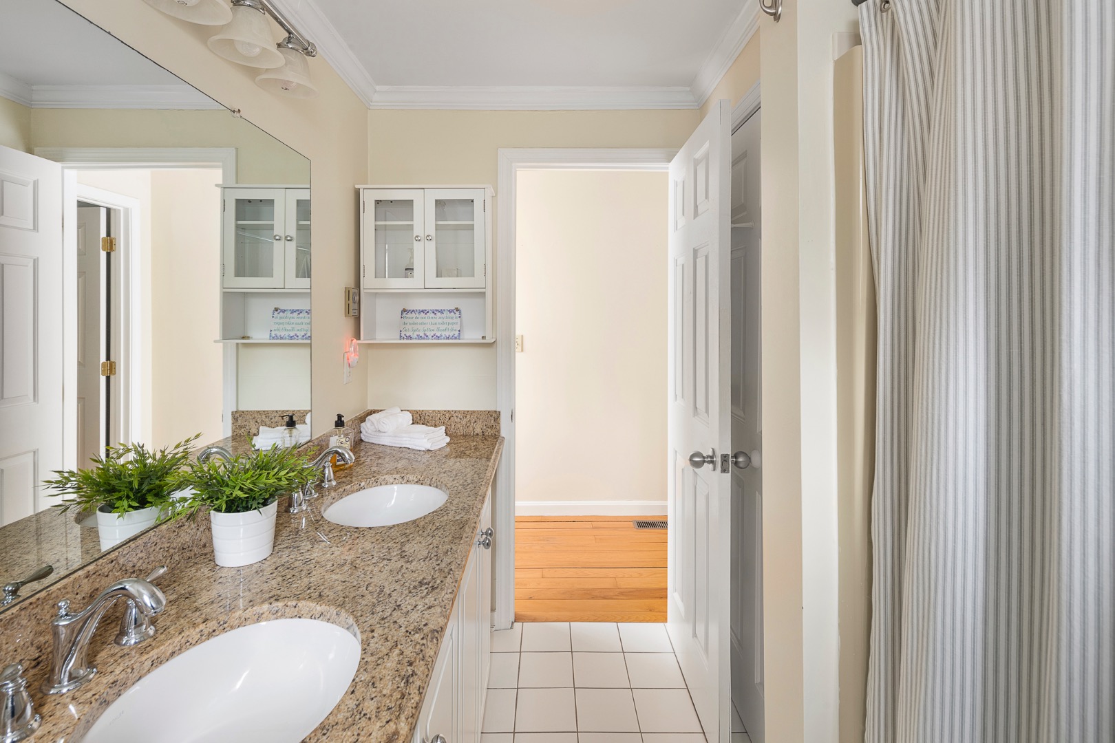 87 Schoolhouse Road Edgartown, MA 02539 - Photo 26 of 29 a bathroom with a granite countertop sink a mirror and a shower
