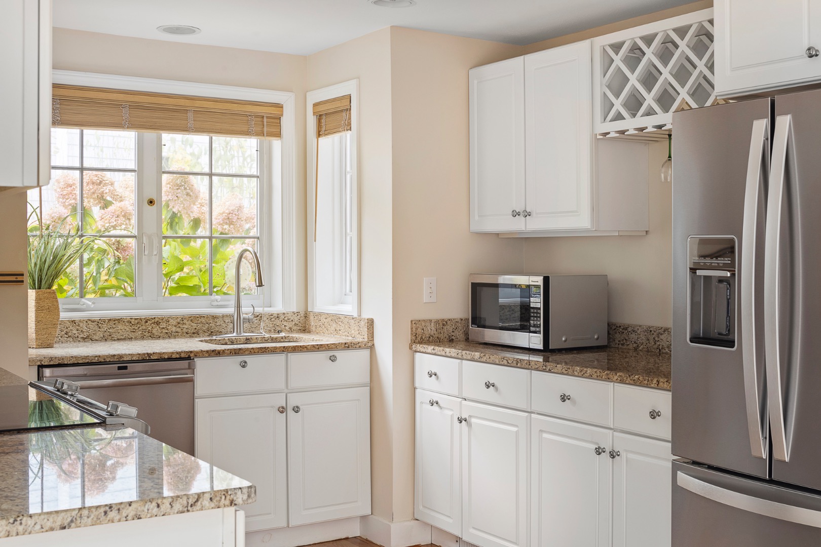 87 Schoolhouse Road Edgartown, MA 02539 - Photo 10 of 29 a kitchen with stainless steel appliances white cabinets and a window