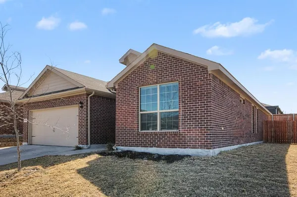 a view of house with backyard