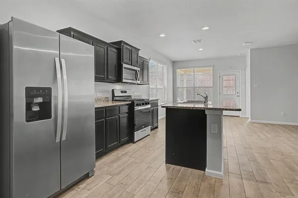 a kitchen with a refrigerator and a sink