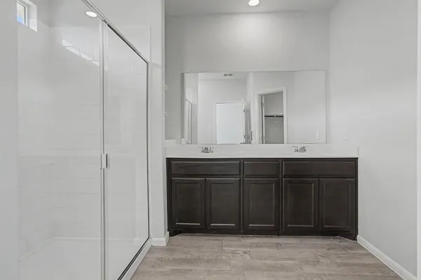 a bathroom with a sink vanity and mirror