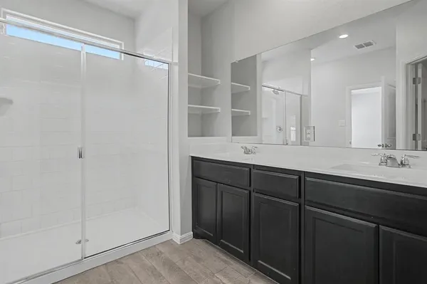 a bathroom with a double vanity sink mirror and double