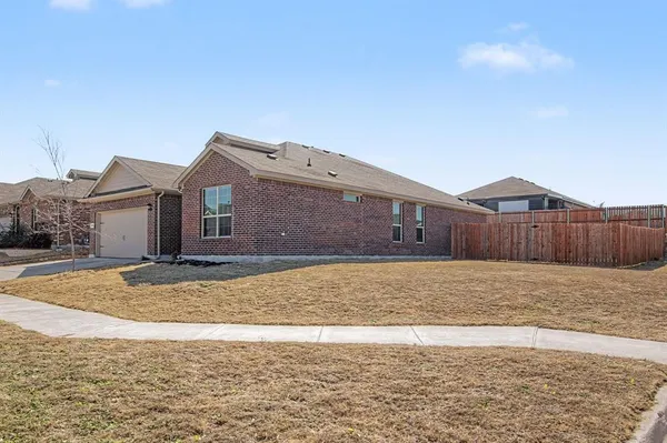 a view of an house with backyard space and wooden fence