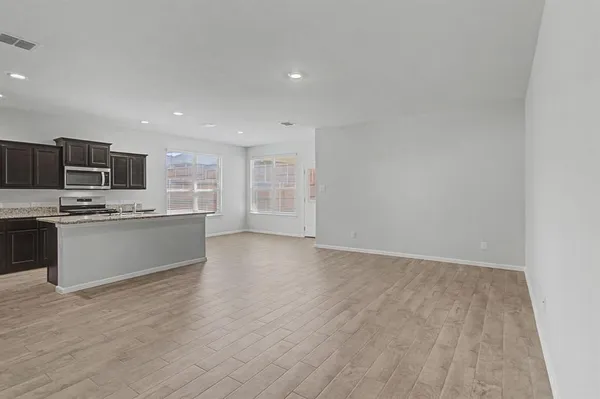 a view of kitchen with granite countertop cabinets and stainless steel appliances