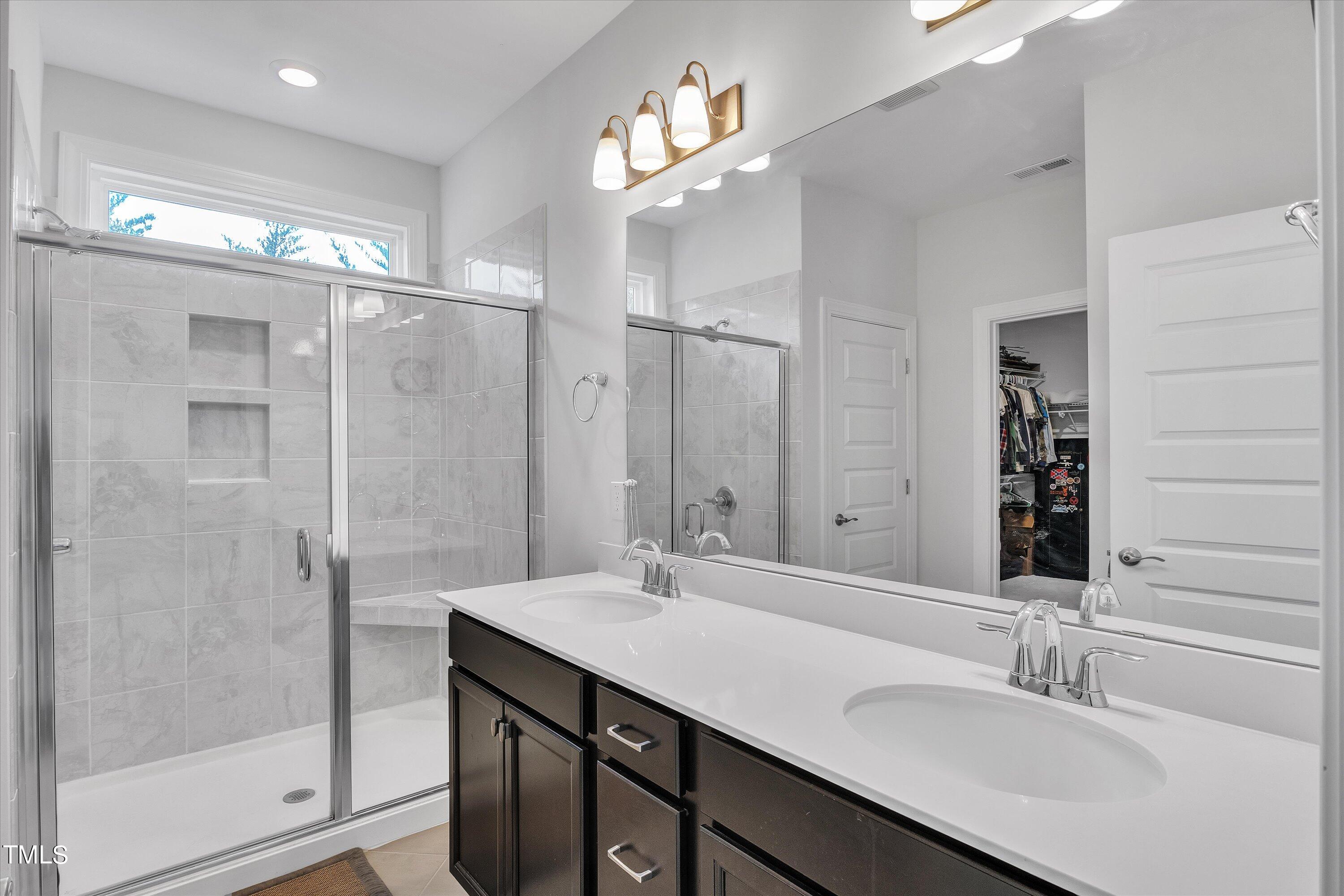 2901 Thurman Dairy Loop Wake Forest, NC 27587 - Photo 16 of 28 a bathroom with a sink shower and a mirror