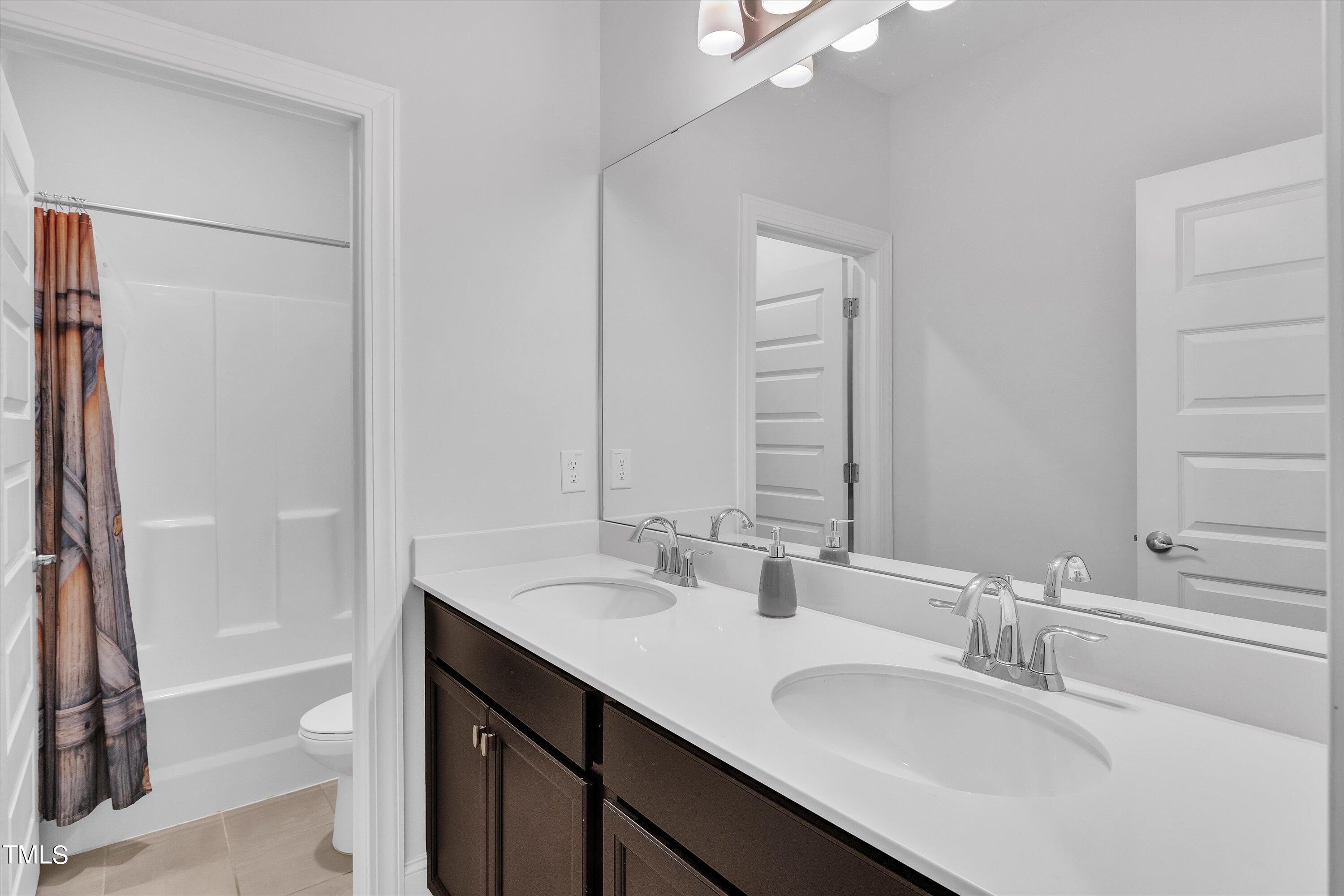 2901 Thurman Dairy Loop Wake Forest, NC 27587 - Photo 20 of 28 a bathroom with a sink a toilet and shower
