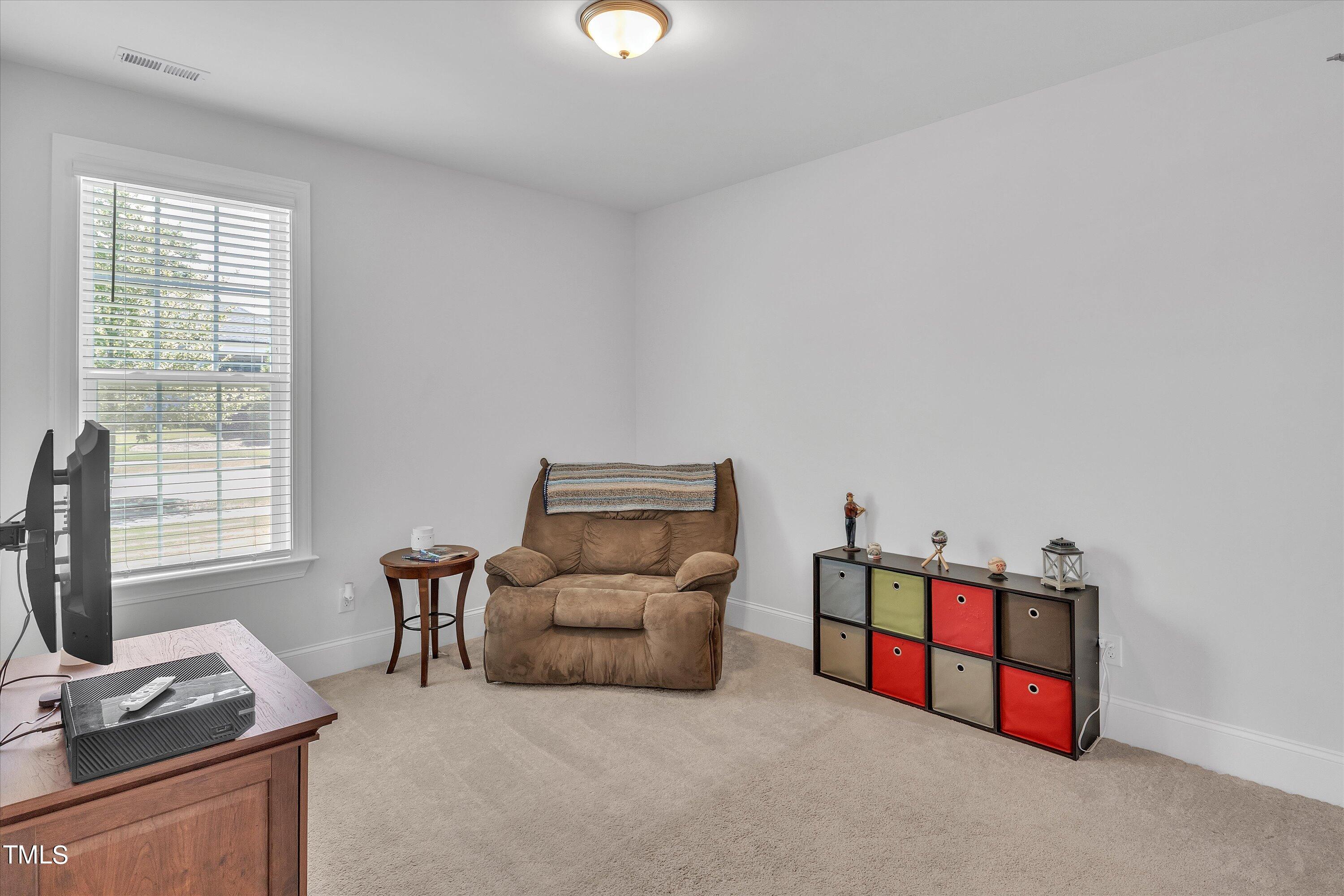2901 Thurman Dairy Loop Wake Forest, NC 27587 - Photo 21 of 28 a living room with furniture and a flat screen tv