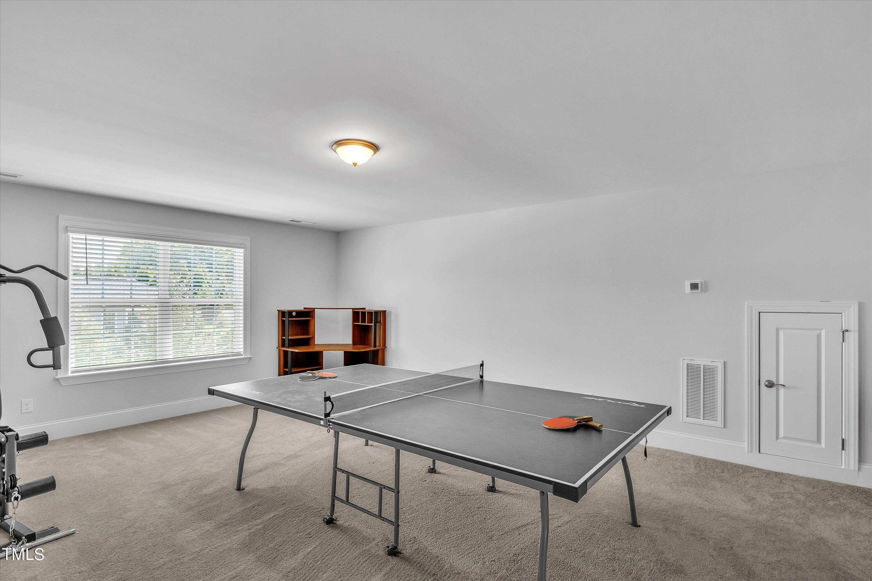 2901 Thurman Dairy Loop Wake Forest, NC 27587 - Photo 25 of 28 a living room with furniture a window and a flat screen tv