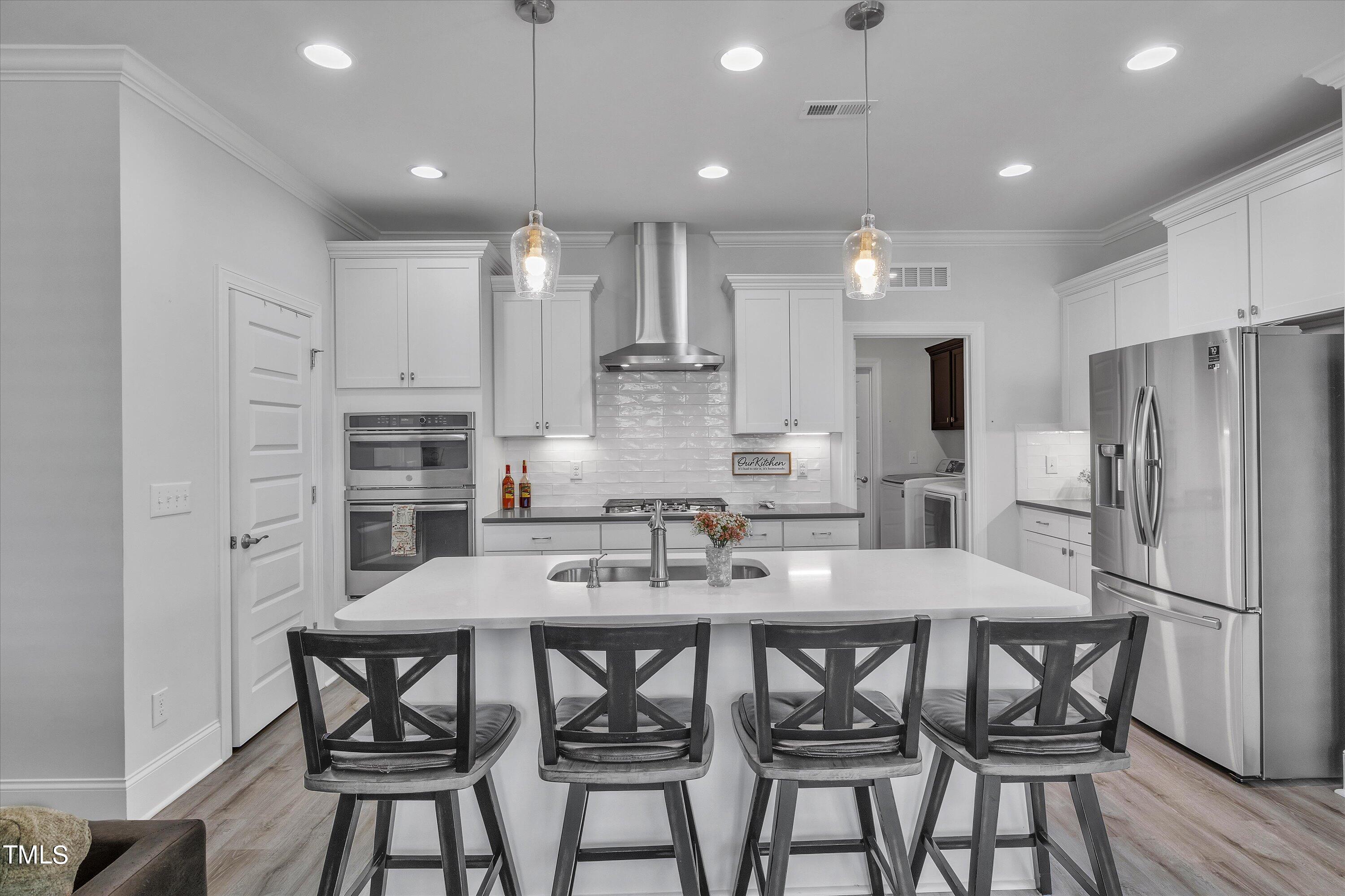 2901 Thurman Dairy Loop Wake Forest, NC 27587 - Photo 6 of 28 a kitchen with kitchen island a refrigerator and dining table