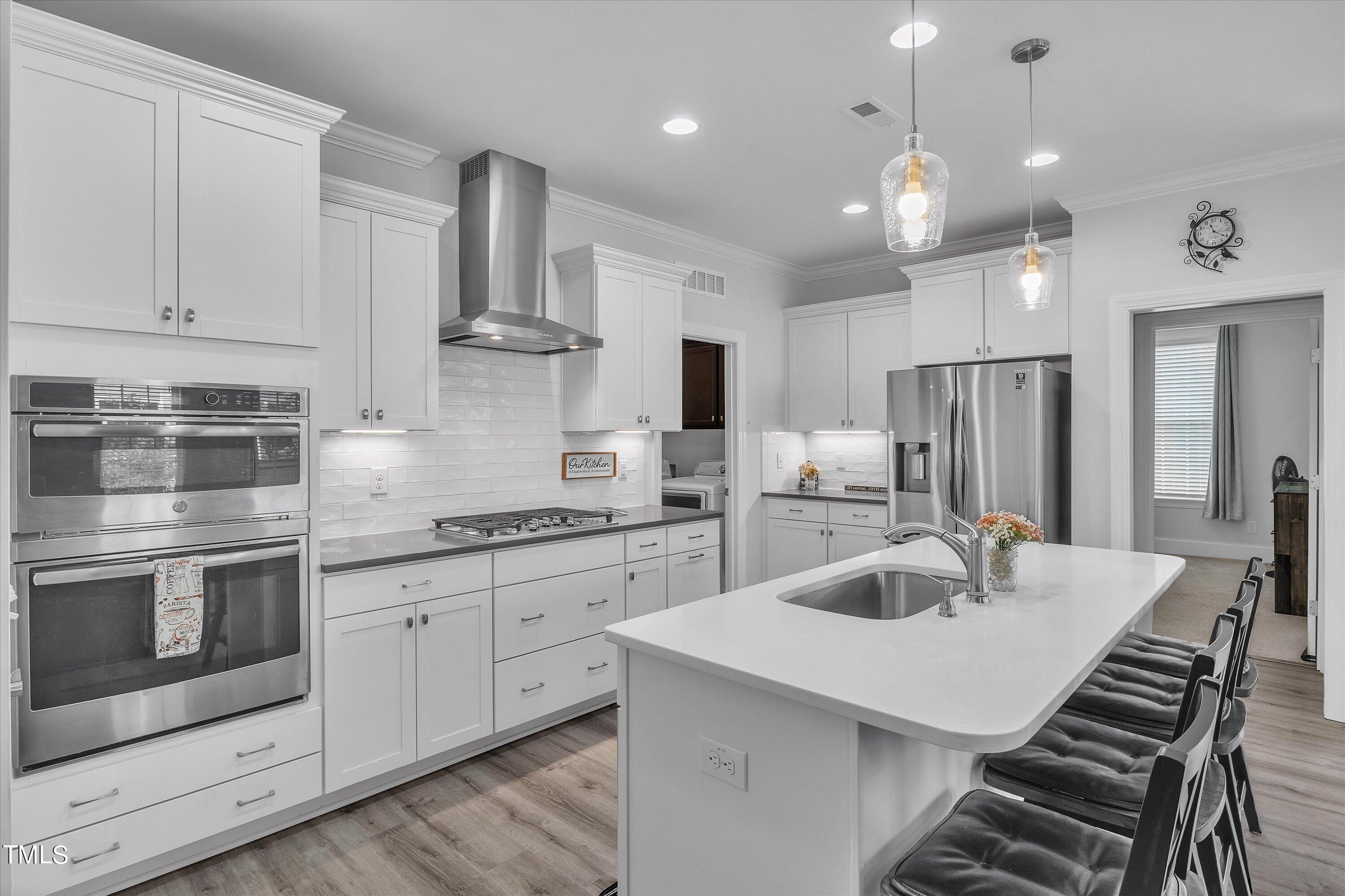 2901 Thurman Dairy Loop Wake Forest, NC 27587 - Photo 8 of 28 a kitchen with stainless steel appliances kitchen island granite countertop a sink a stove and refrigerator
