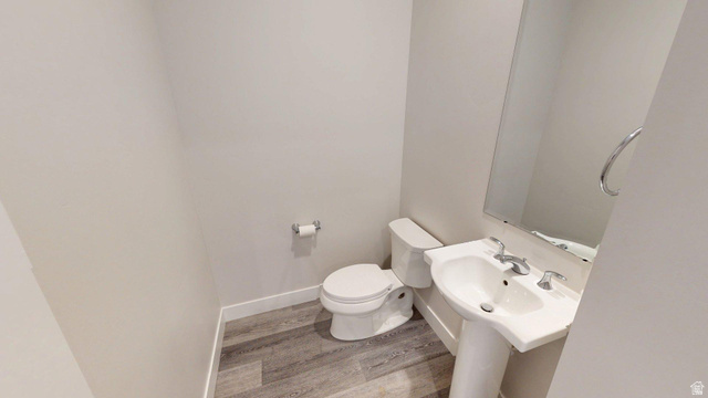 5502 North Valley View Road Lehi, UT 84048 - Photo 15 of 33 Powder room featuring a pedestal sink with chrome fixtures, a wall-mounted mirror, and wood-finish flooring