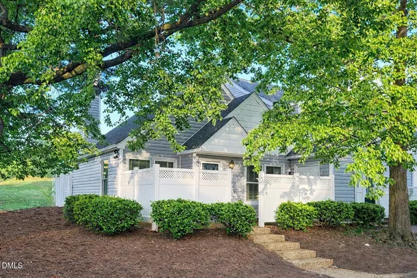 front view of a house with a tree
