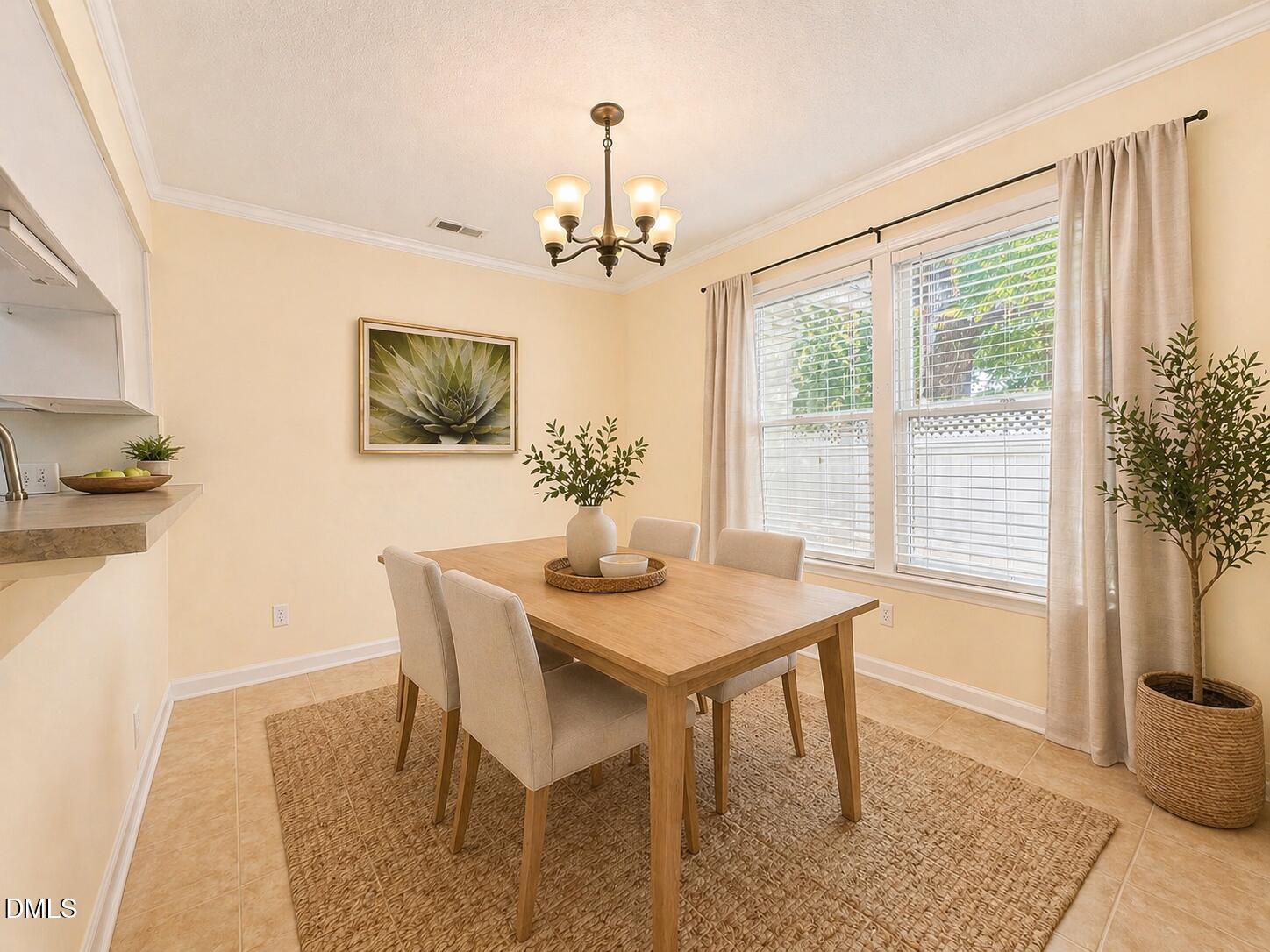 5010 Avenida Del Sol Drive Raleigh, NC 27616 - Photo 10 of 27 a view of a dining room with furniture window and wooden floor