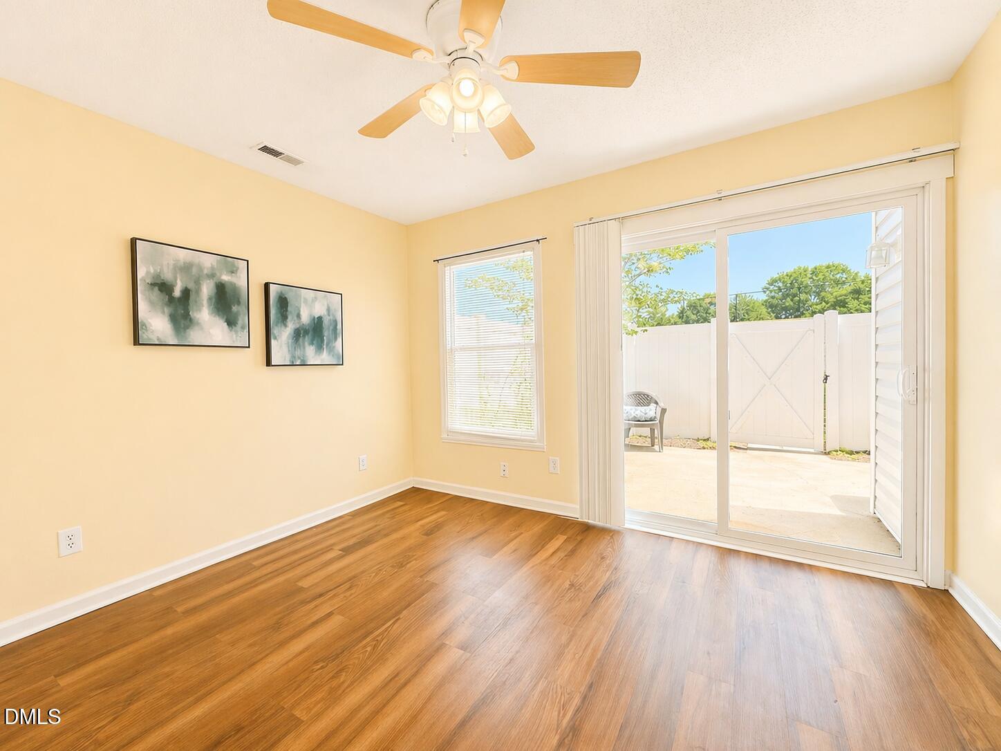 5010 Avenida Del Sol Drive Raleigh, NC 27616 - Photo 16 of 27 a view of an empty room with a window and wooden floor