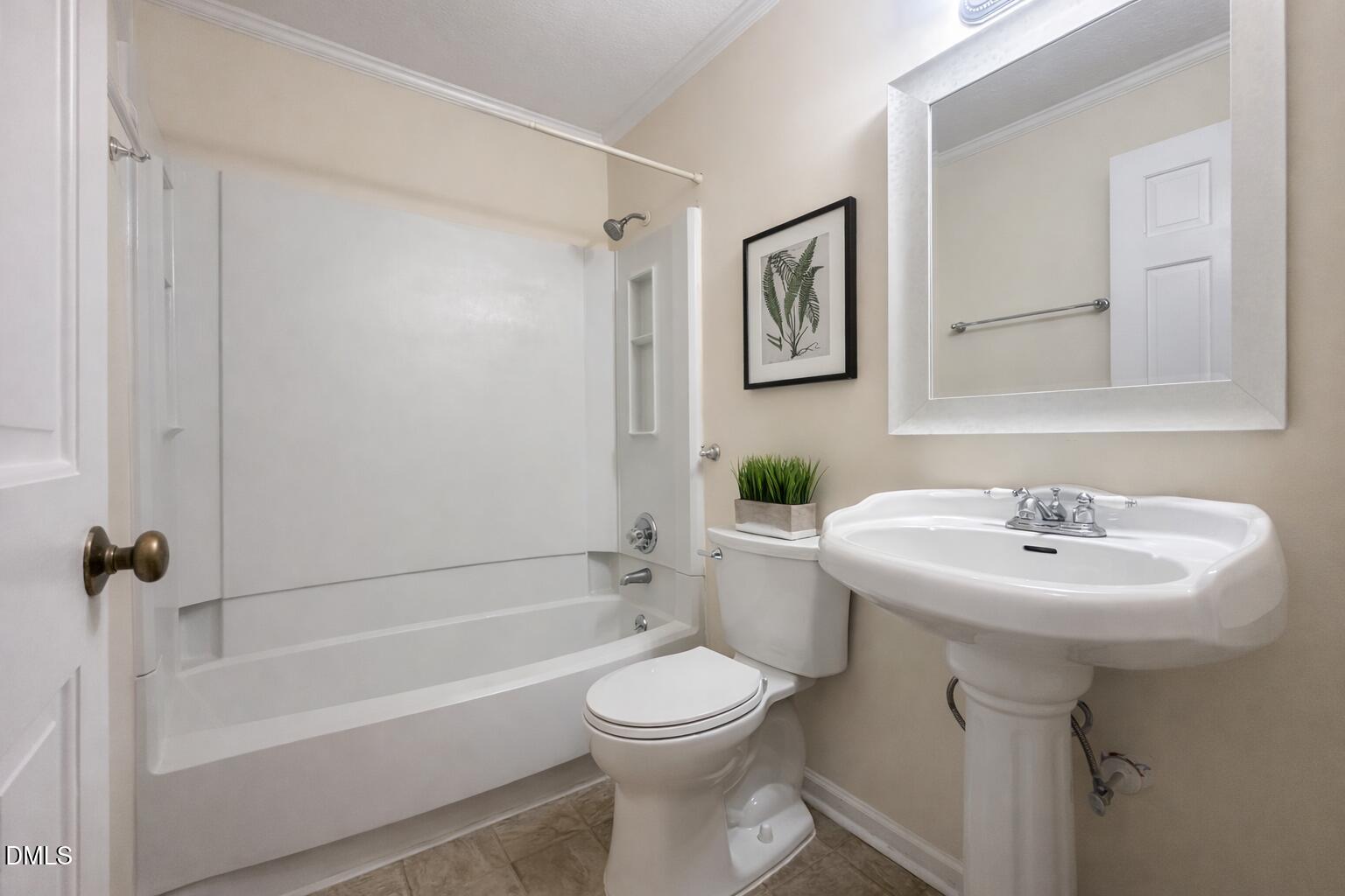 5010 Avenida Del Sol Drive Raleigh, NC 27616 - Photo 19 of 27 a bathroom with a sink a toilet and a bathtub