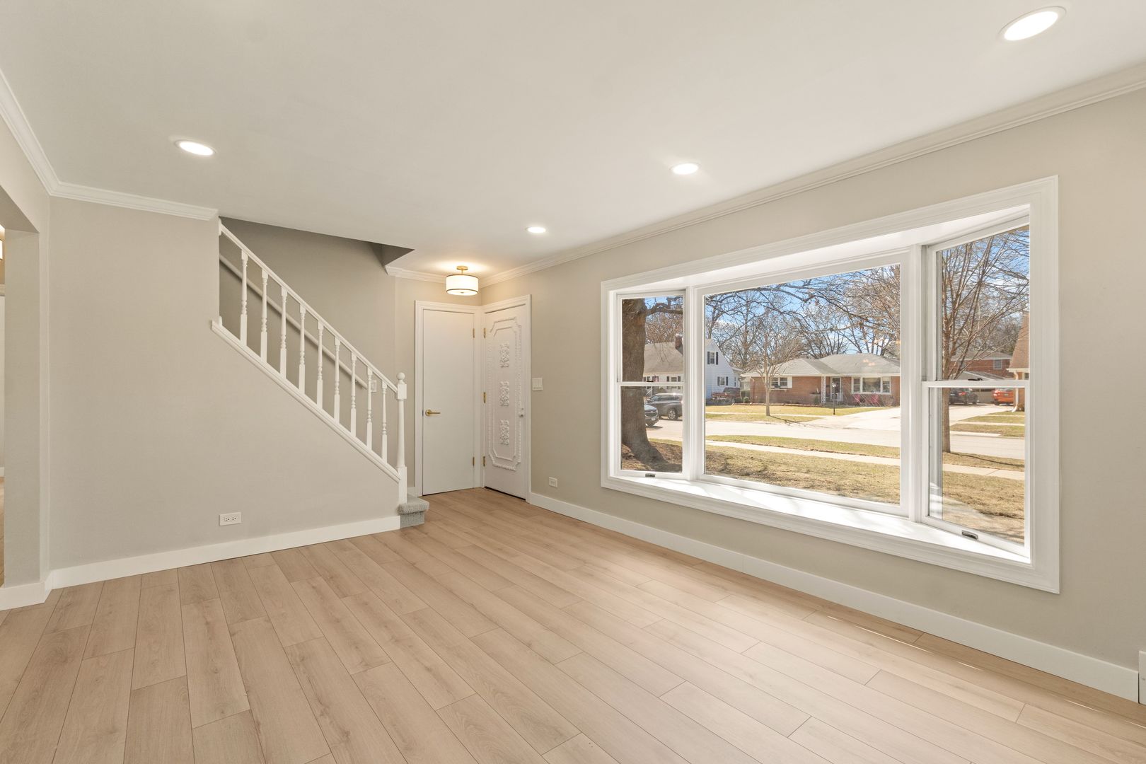 219 North Pine Street Mount Prospect, IL 60056 - Photo 8 of 20 a view of an empty room with wooden floor and a window