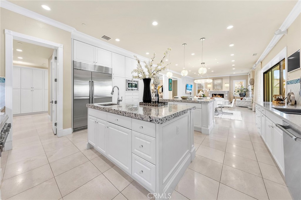 123 Calderon Irvine, CA 92618 - Photo 24 of 74 a large white kitchen with a large counter top and stainless steel appliances