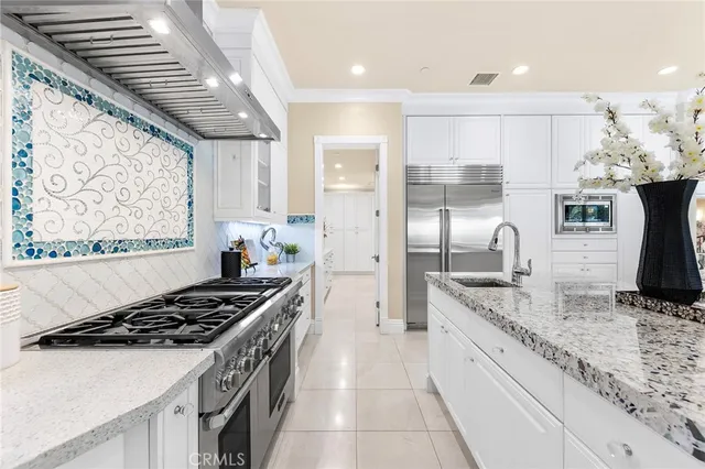 a spacious bedroom with a bed and a chandelier