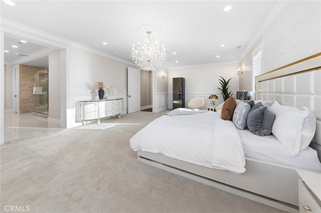 123 Calderon Irvine, CA 92618 - Photo 38 of 74 a spacious bedroom with a bed and a chandelier