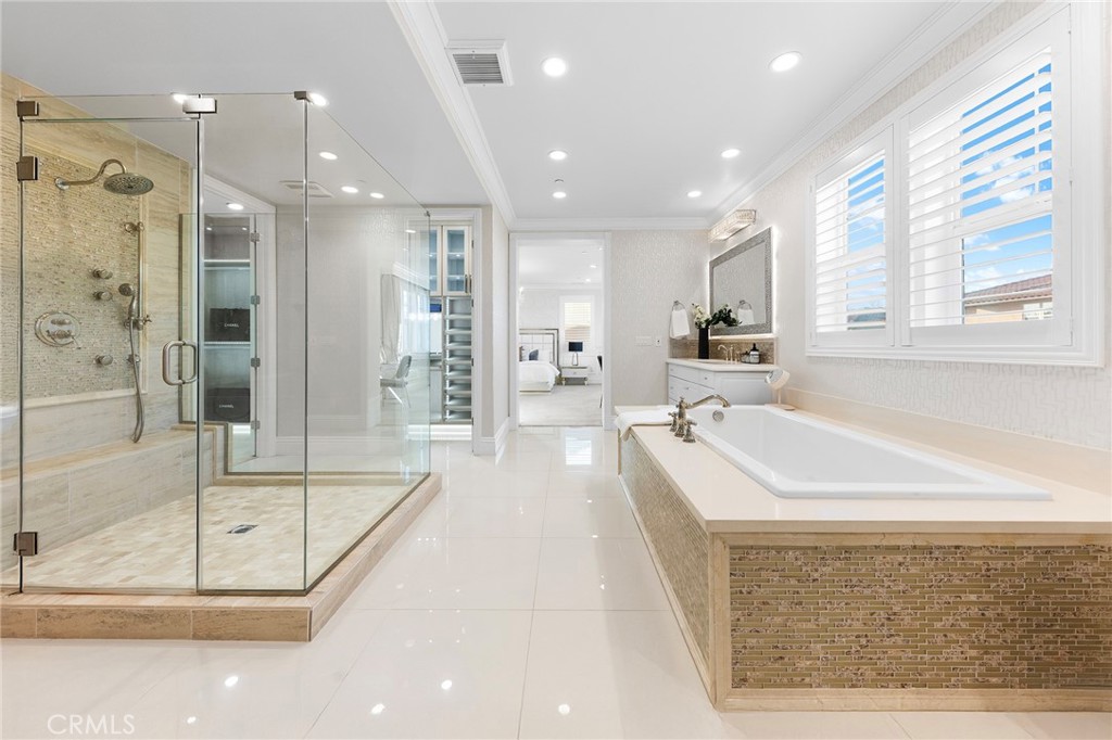 123 Calderon Irvine, CA 92618 - Photo 39 of 74 a large bathroom with a tub a shower a sink and mirror