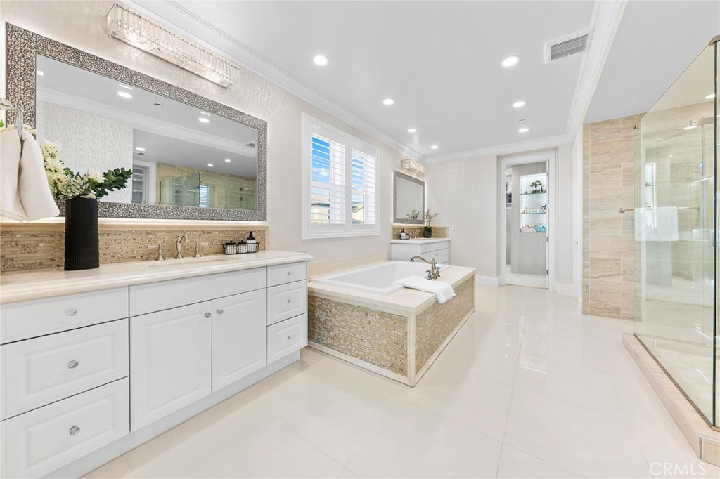 123 Calderon Irvine, CA 92618 - Photo 40 of 74 a spacious bathroom with a double vanity sink a mirror and a shower