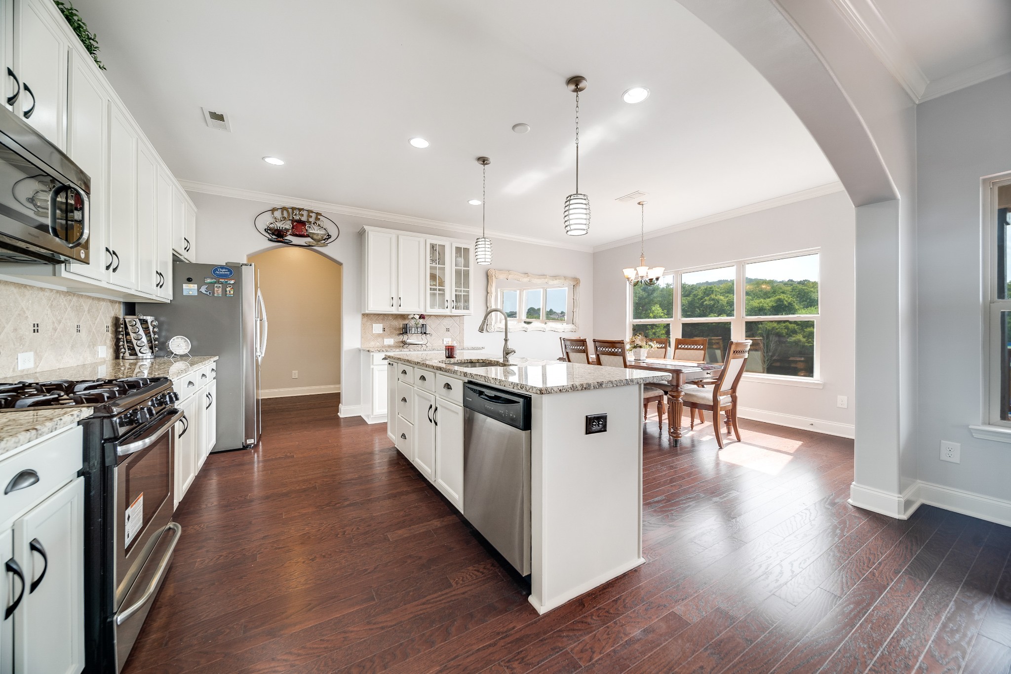 238 Fowler Circle Franklin, TN 37064 - Photo 12 of 45 a kitchen with stainless steel appliances kitchen island granite countertop a stove a sink a refrigerator and chairs