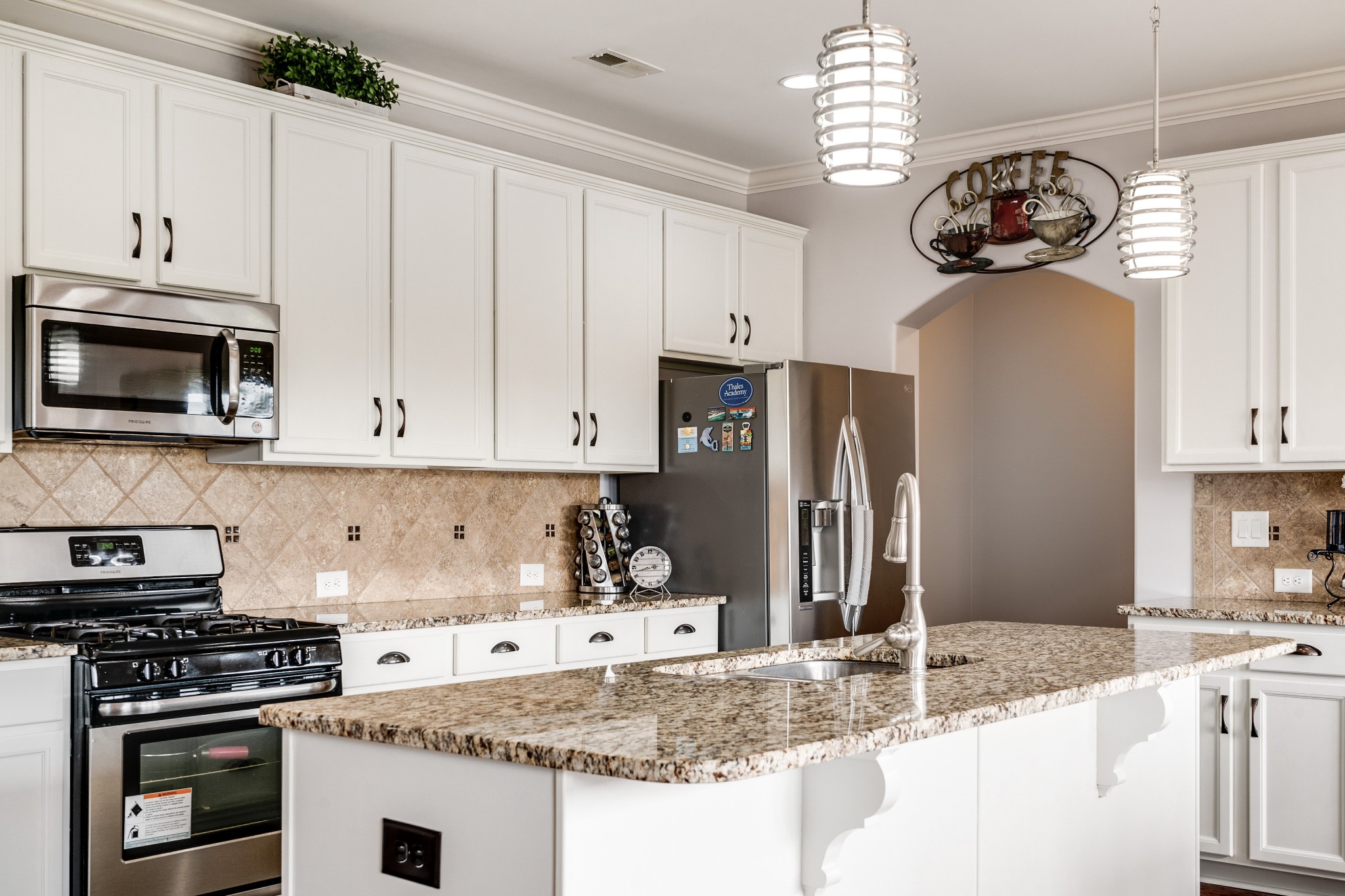 238 Fowler Circle Franklin, TN 37064 - Photo 14 of 45 a kitchen with granite countertop a sink stainless steel appliances and white cabinets