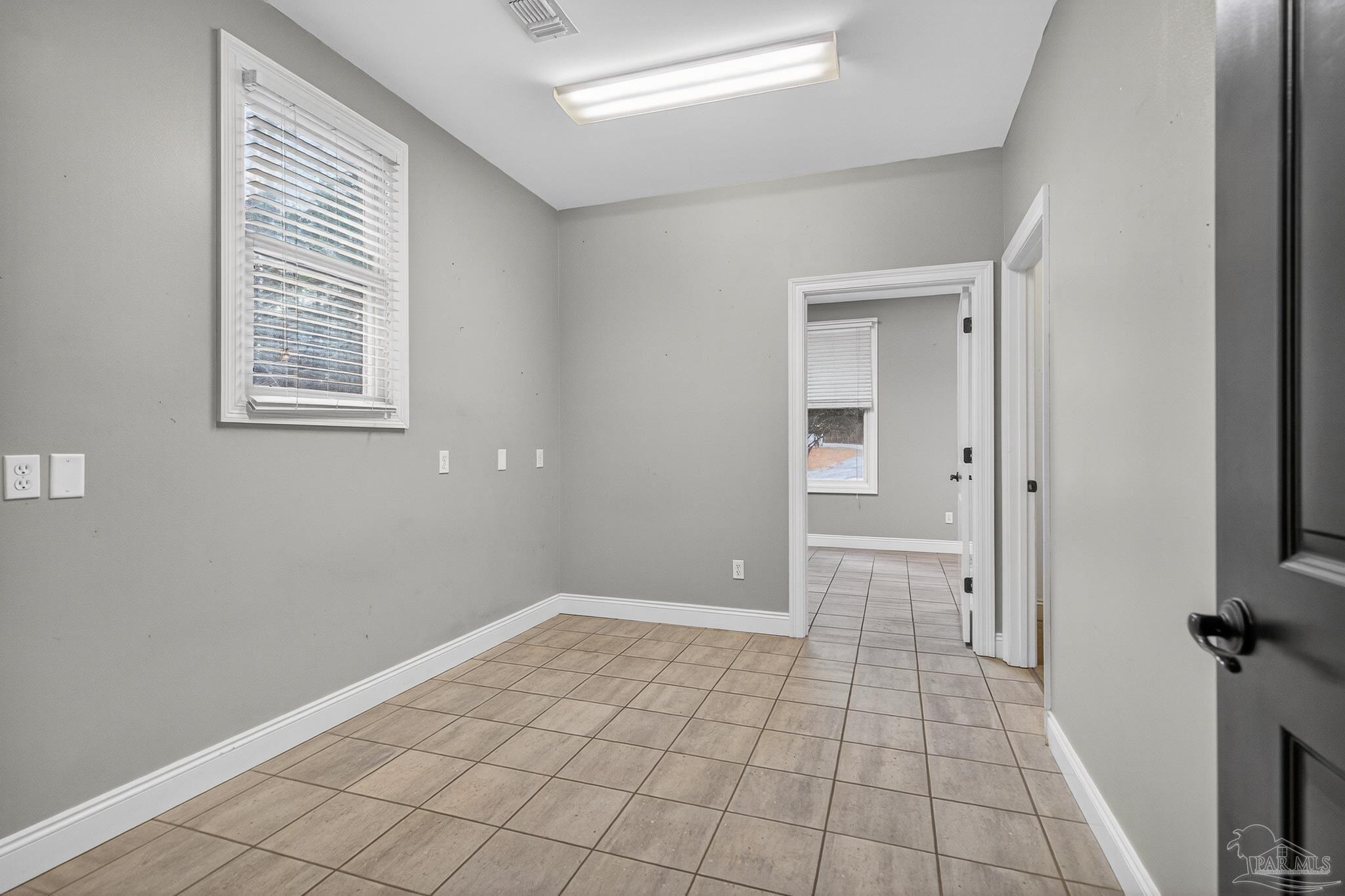 78 Hummingbird Lane Atmore, AL 36502 - Photo 36 of 55 a view of an empty room with window and stairs