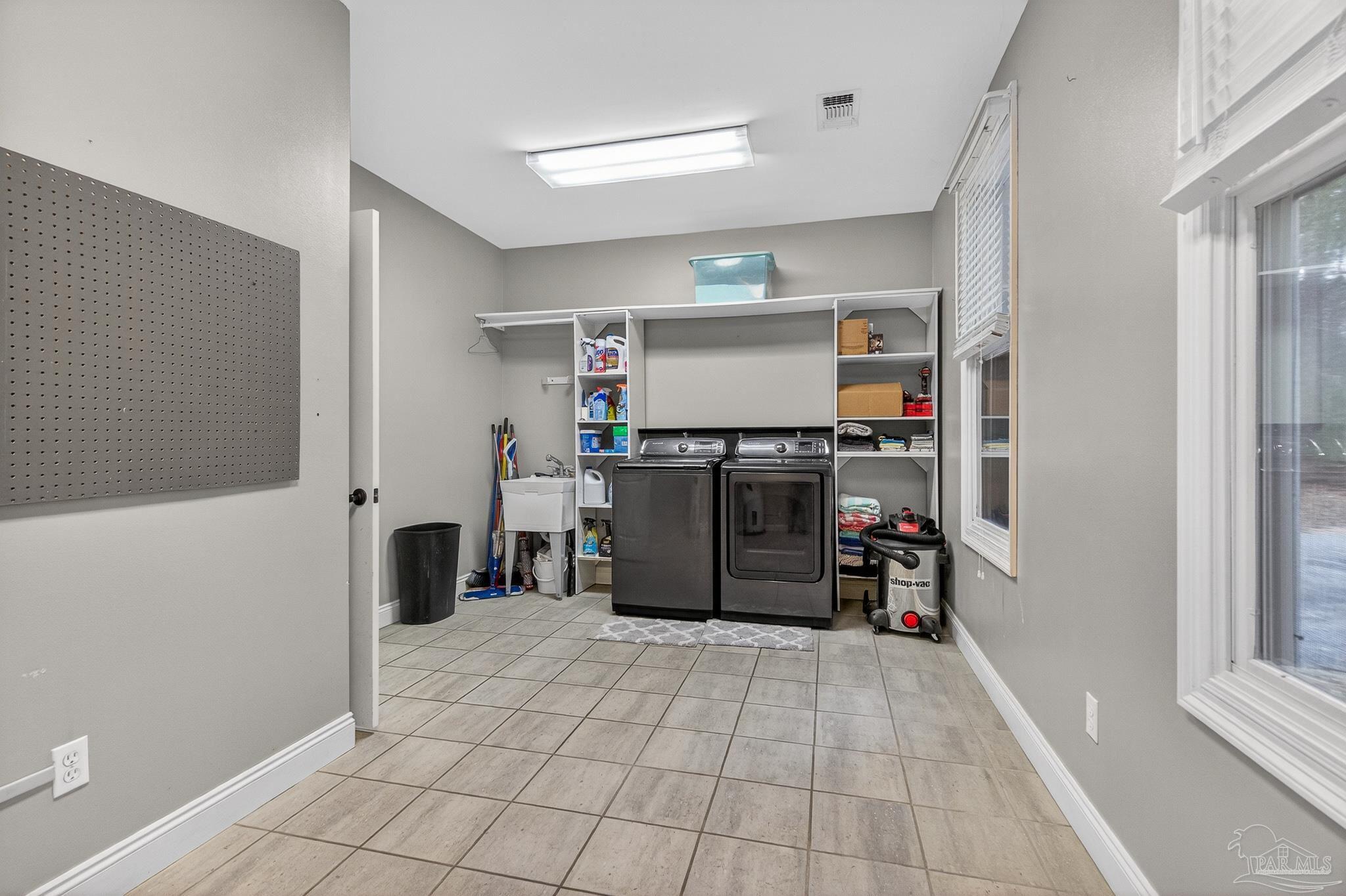 78 Hummingbird Lane Atmore, AL 36502 - Photo 40 of 55 a kitchen with stainless steel appliances a refrigerator and cabinets