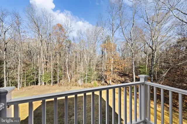 a kitchen with stainless steel appliances granite countertop a refrigerator a sink dishwasher and a fireplace with wooden floor