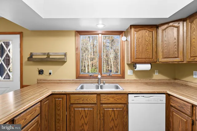 a view of an empty room with a fireplace and a window