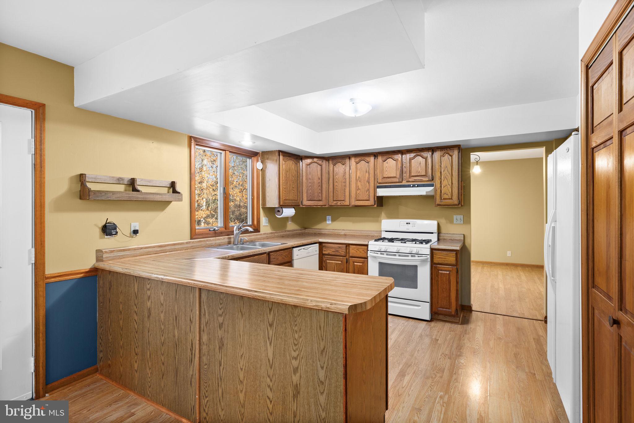 4075 Red Gate Lane King George, VA 22485 - Photo 29 of 69 a kitchen with stainless steel appliances granite countertop a sink stove and refrigerator