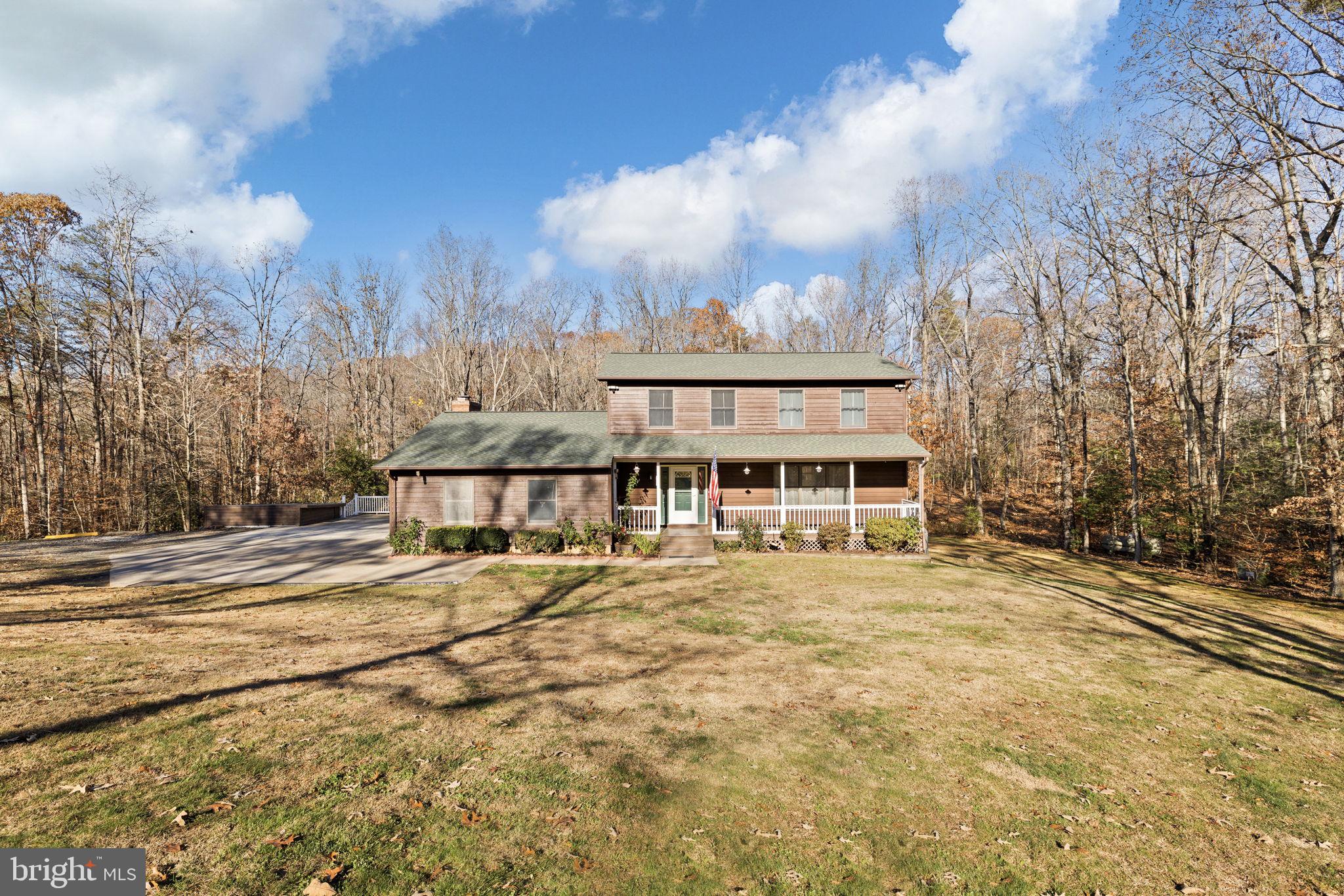 4075 Red Gate Lane King George, VA 22485 - Photo 8 of 69 a view of a house with a big yard and large trees