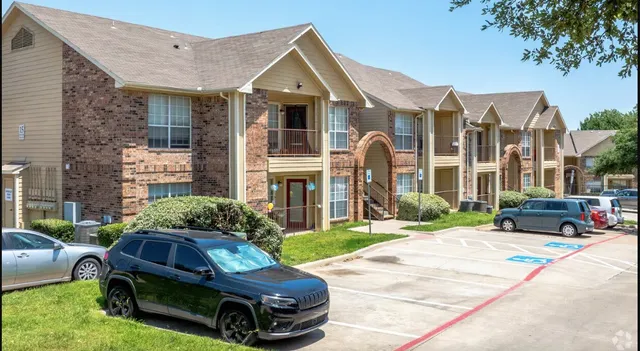 a car parked in front of a brick house with a large window