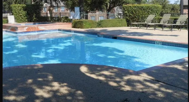 a view of yard with swimming pool and seating