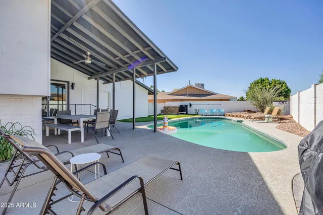 a living room with furniture a rug and white walls