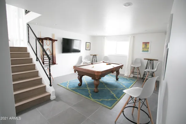 a kitchen with stainless steel appliances a dining table and chairs