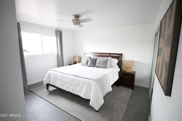 a kitchen with stainless steel appliances kitchen island granite countertop a dining table chairs and a refrigerator