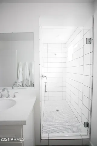 a bedroom with a bed and a ceiling fan