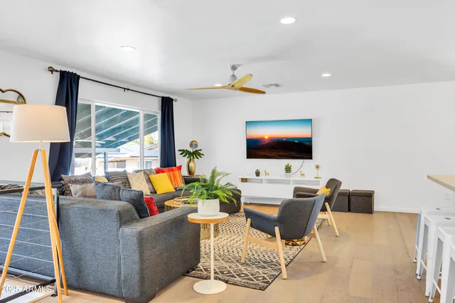 a living room with furniture kitchen view and a table