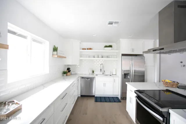 a view of a backyard with table and chairs