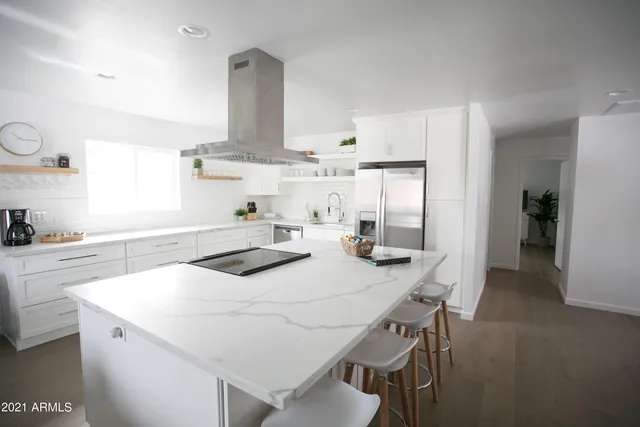 a bedroom with a bed and a potted plant