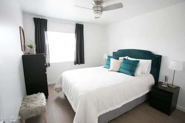 a bedroom with a bed and a lamp