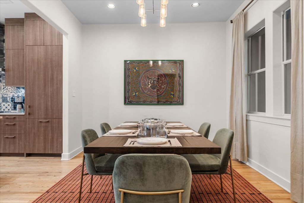1529 Barton Springs Road, Unit 27 Austin, TX 78704 - Photo 38 of 40 An inviting dining area offers seamless entertaining, complemented by warm hardwood flooring and ample natural light.