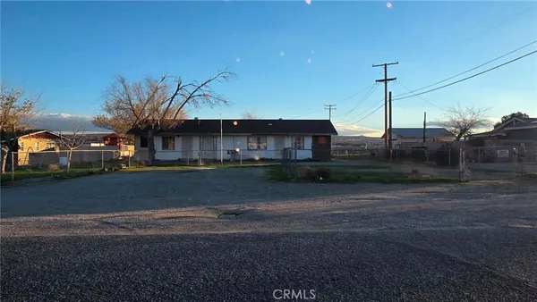 a front view of a house with a road