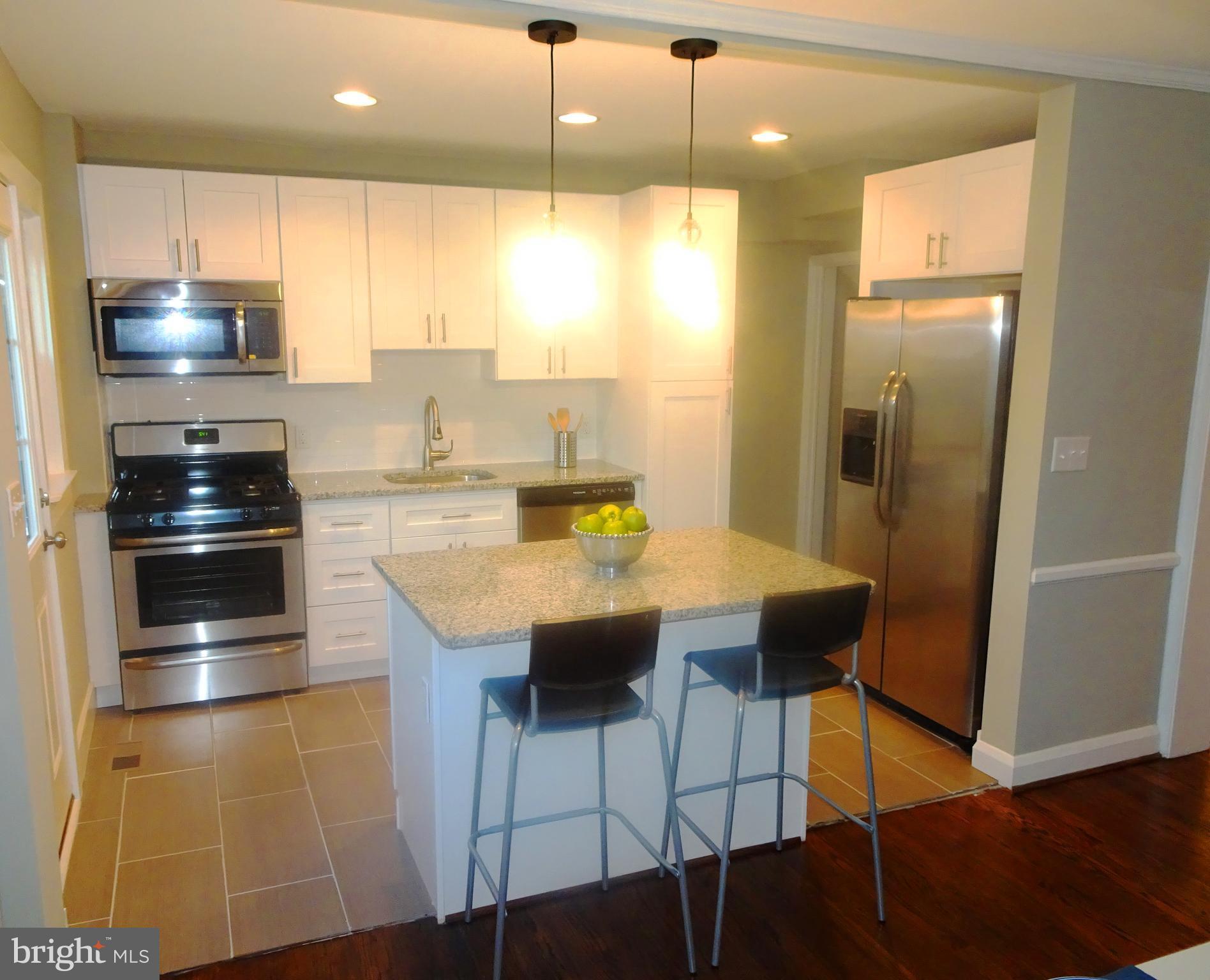 1406 Meridene Drive Baltimore, MD 21239 - Photo 28 of 30 a kitchen with stainless steel appliances granite countertop a sink a stove and a refrigerator